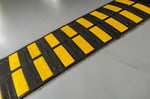 striped-black-and-yellow-speed-bump-on-a-road-2026-03-16-02-06-53-utc